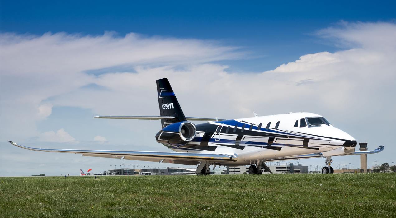 A picture of an aircraft parked on an open field